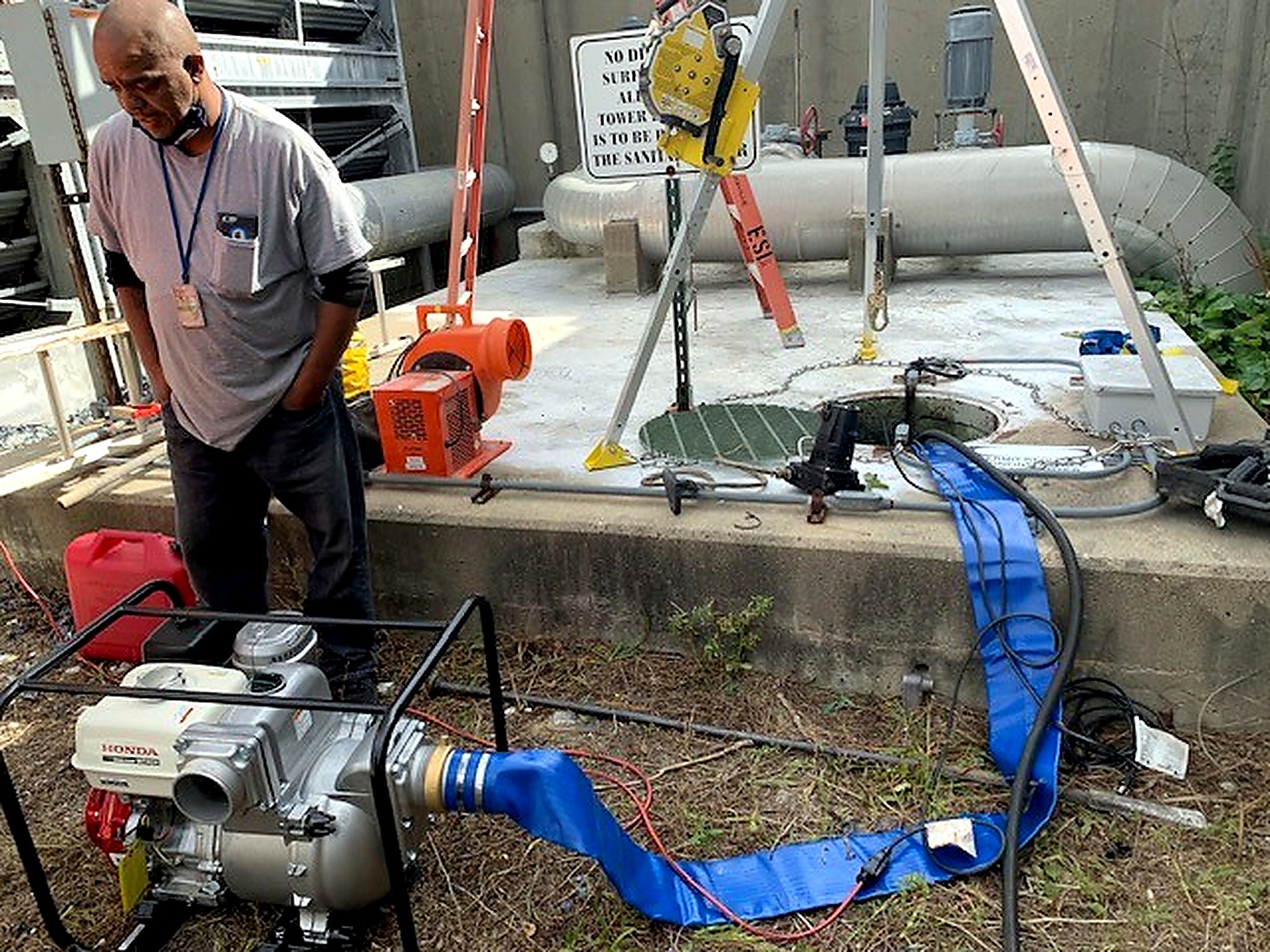 Crew member operating pumping equipment during facility maintenance at Wright-Patterson Air Force Base