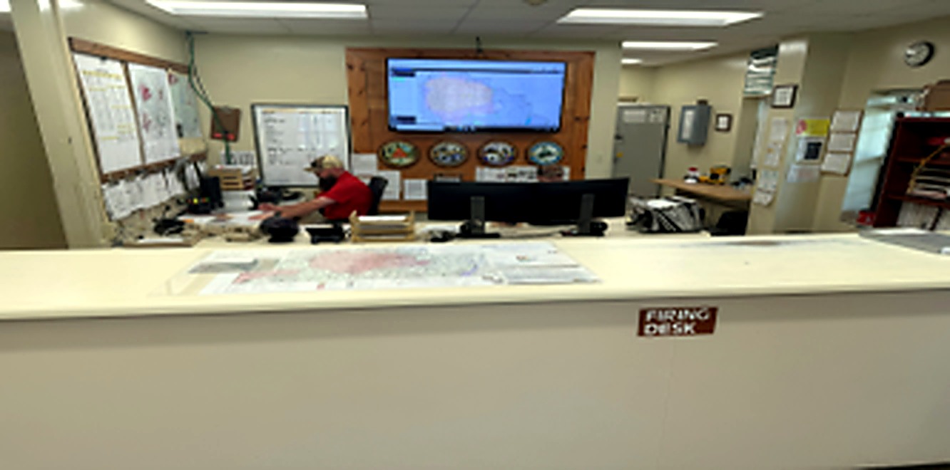 Indoor firing desk with range monitoring equipment and control screens
