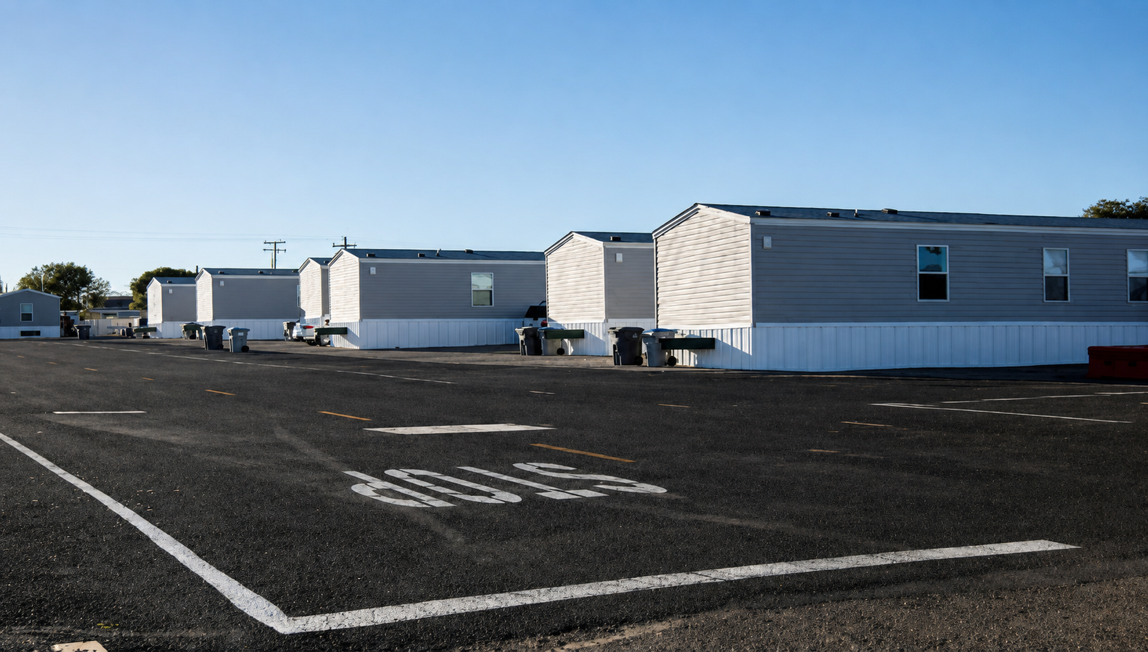 Row of temporary housing units with paved parking