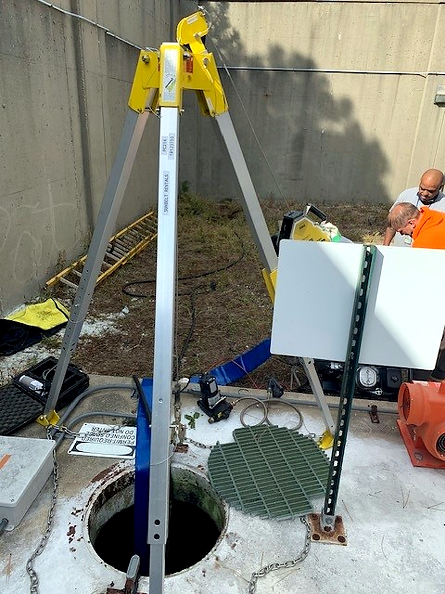 Tripod safety system positioned over a facility access opening at Wright-Patterson Air Force Base